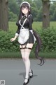 A woman in a maid outfit is walking down the street.