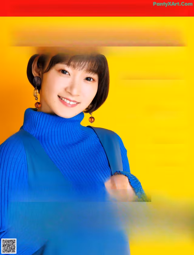 A magazine with a woman in a blue sweater on the cover.