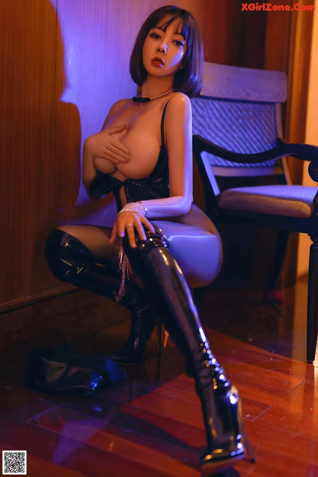 A woman sitting on a chair in a room.