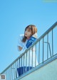 A woman standing on top of a metal railing.