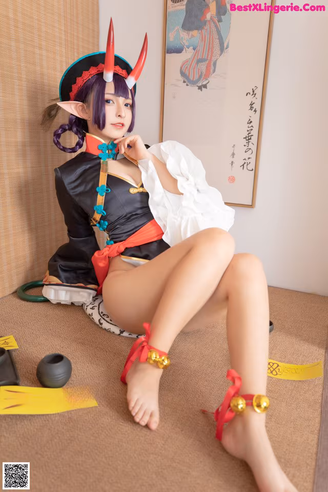 A woman in a costume sitting on the floor.